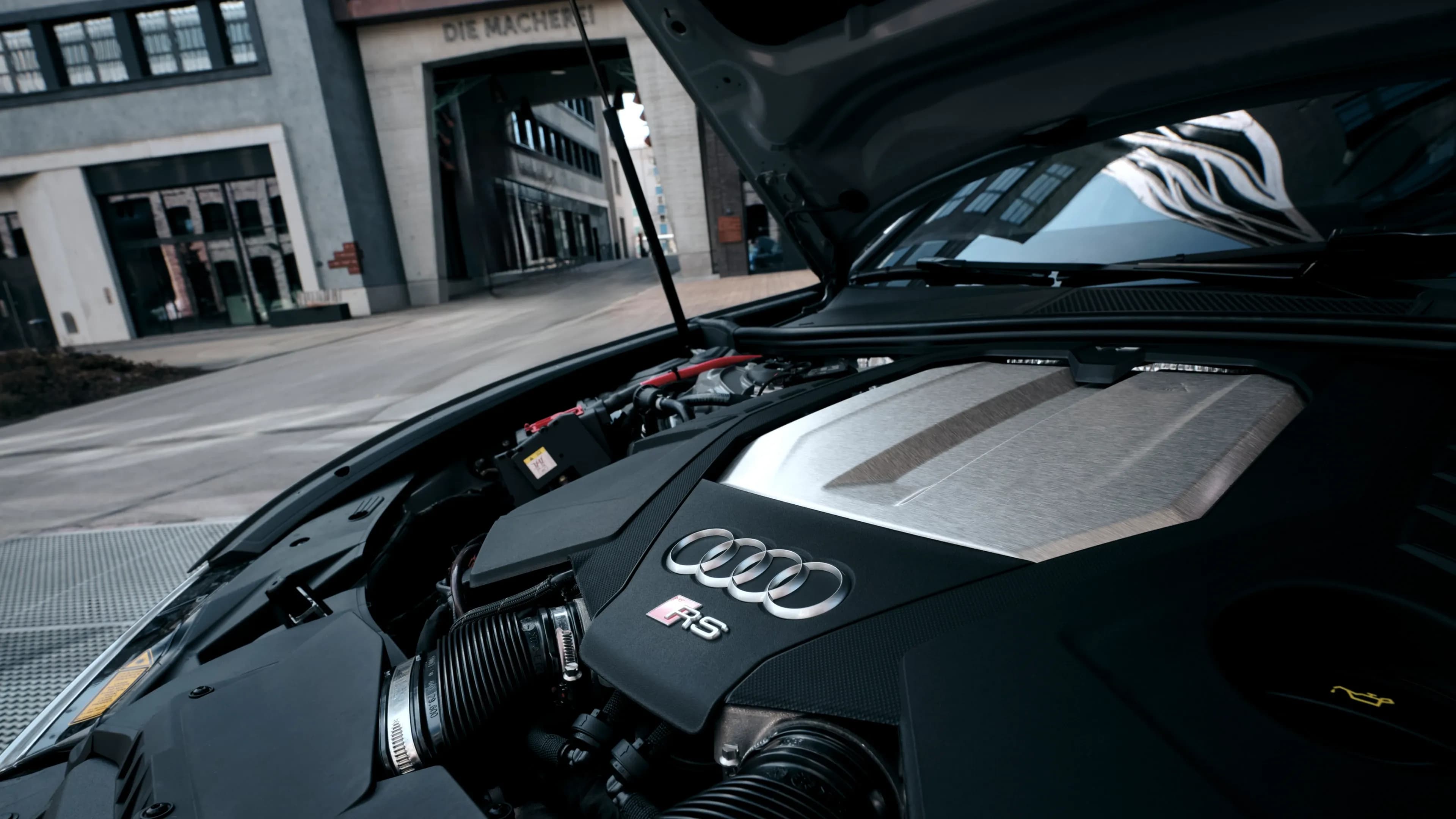 Detail view of the Audi RS6 Performance door panel featuring blue carbon fibre trim by Mosaik Motors.