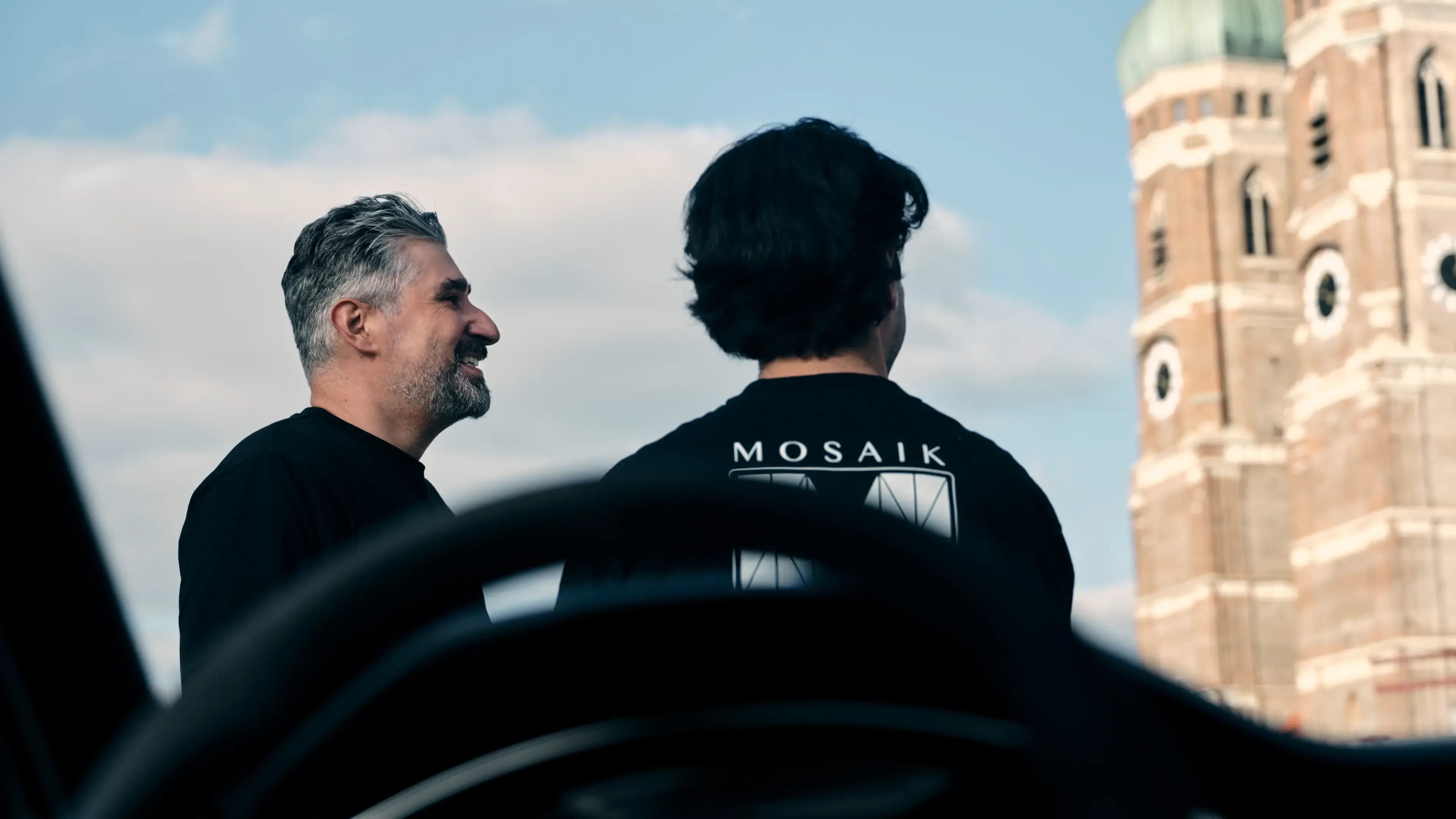 The founders team of Mosaik Motors in front of the iconic Frauenkirche in Munich – your experts for exclusive luxury car rental and premium chauffeur services.